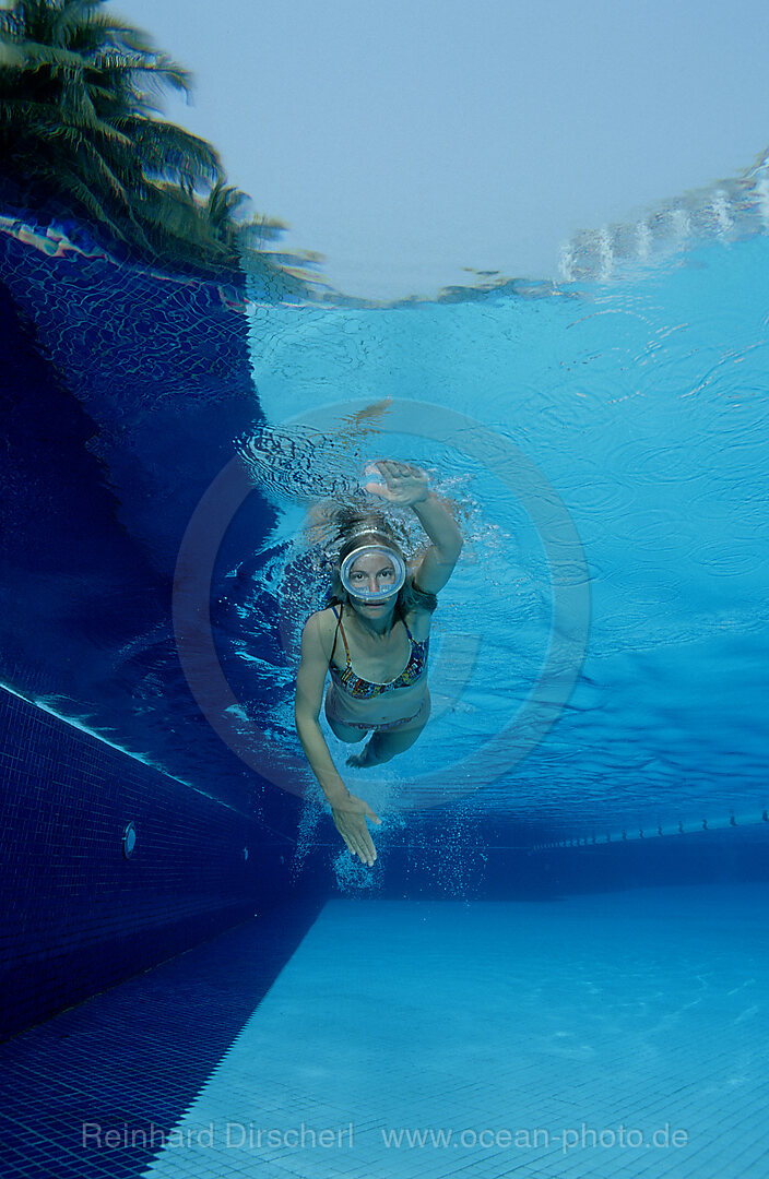 Woman swims in swimming pool, Bavaria, Germany