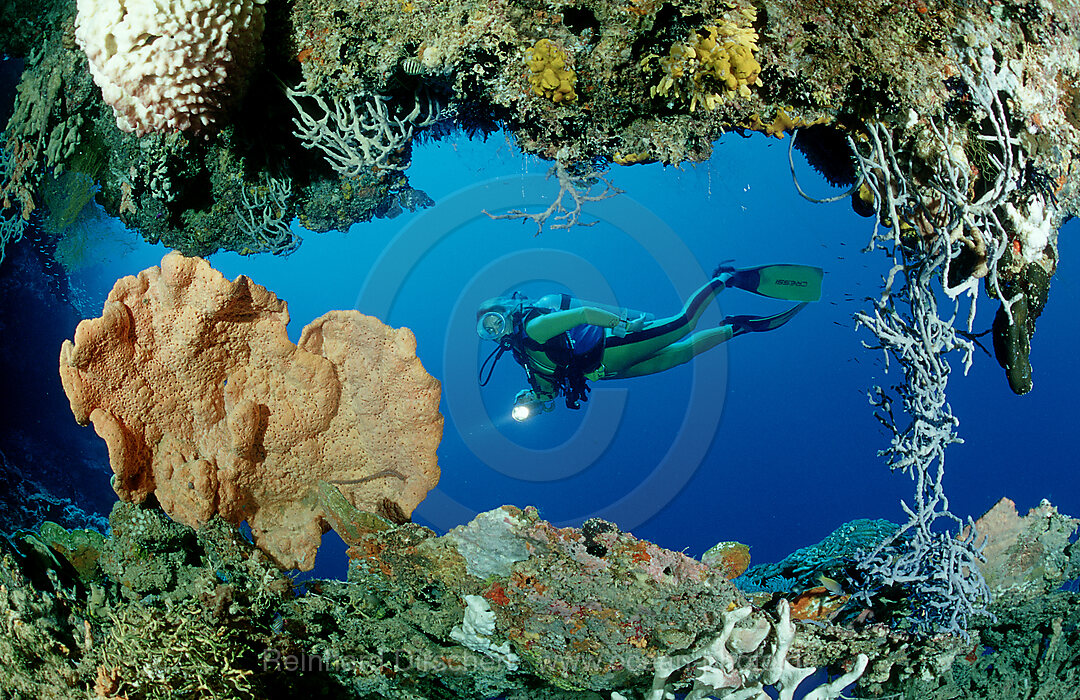 scuba diver and underwater cave, Pacific ocean, Papua New Guinea