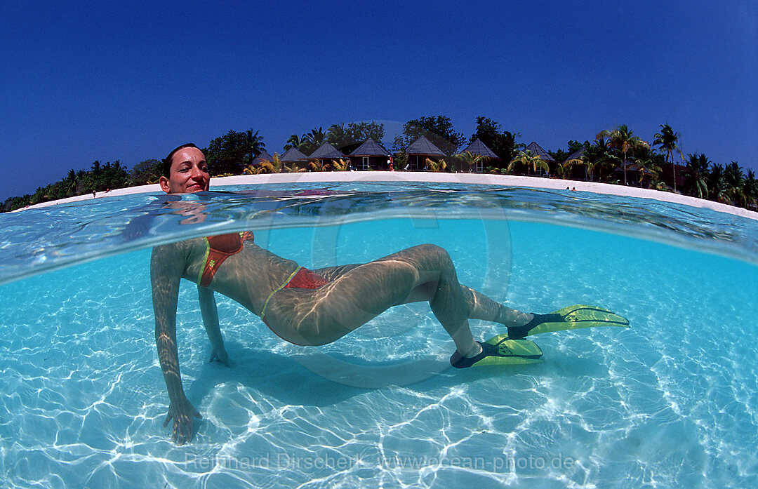 Snorkeling woman near maldives island Kuredu