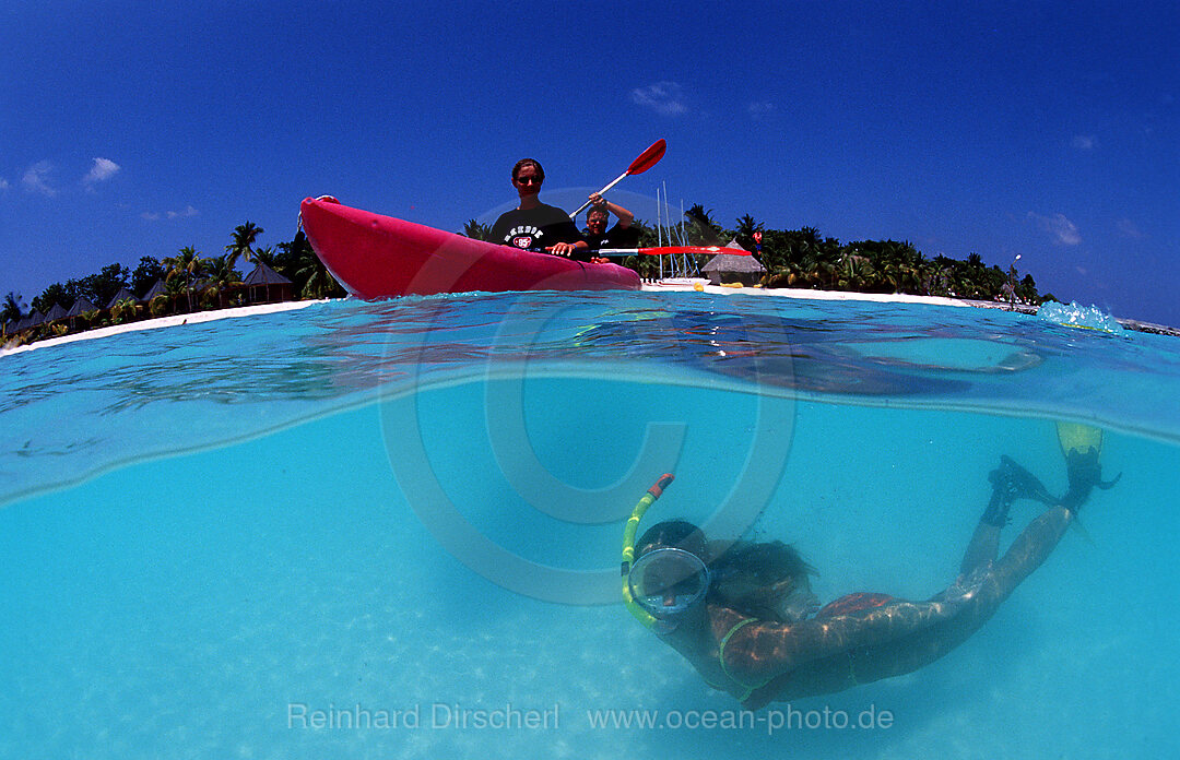 Snorkeling woman near maldives island Kuredu