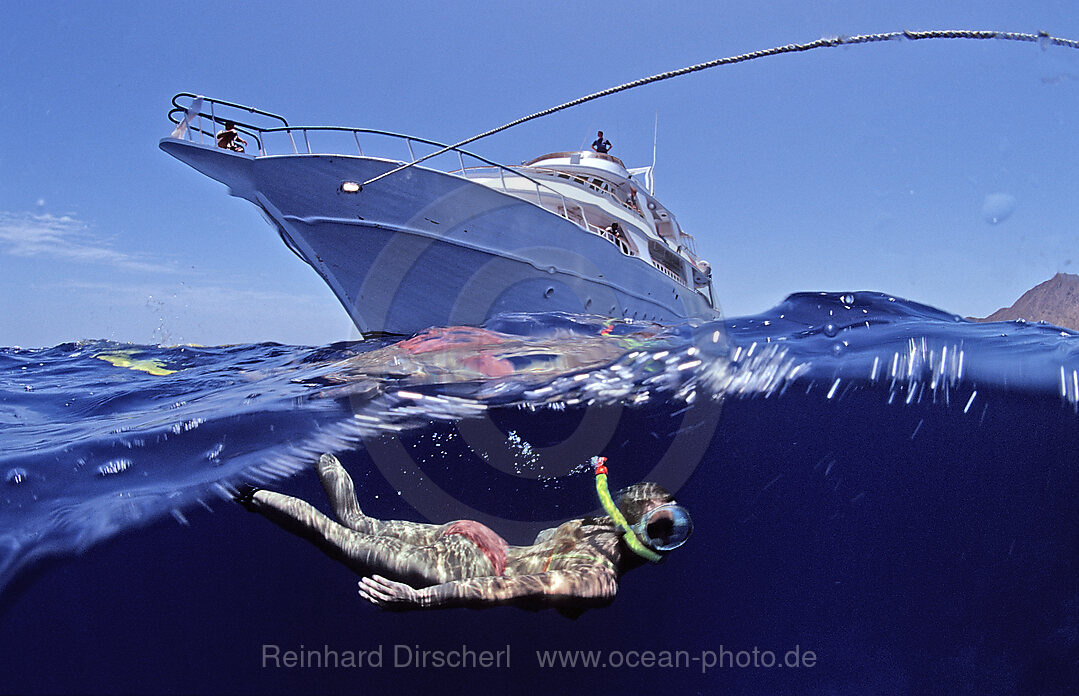 Snorkelung in front of a yacht
