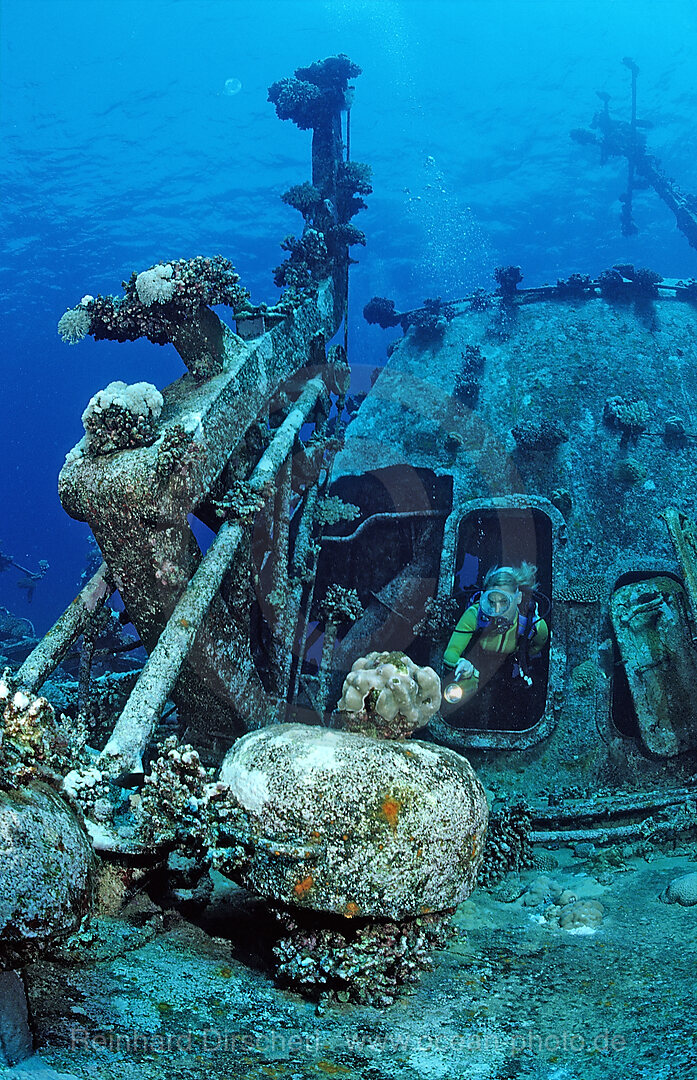 scuba diver explores unknown ship wreck