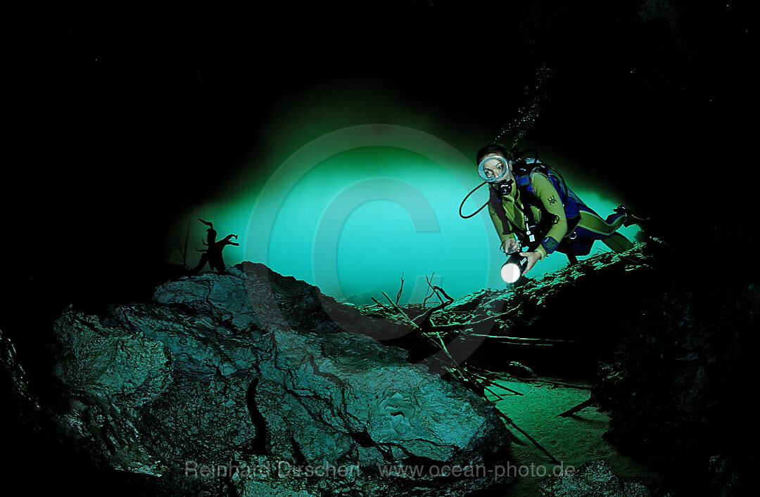 Scuba diver in underwater cave Laguna Pepe