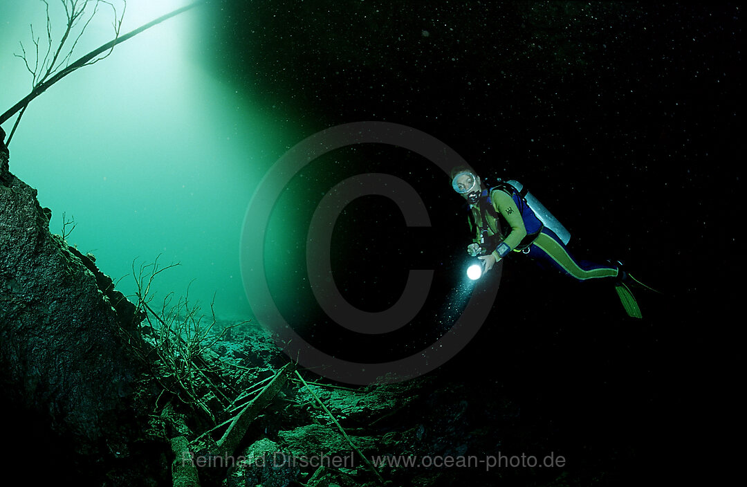 Scuba diver in underwater cave Laguna Pepe
