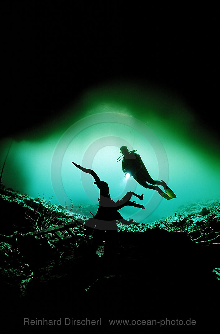 Scuba diver in underwater cave Laguna Pepe