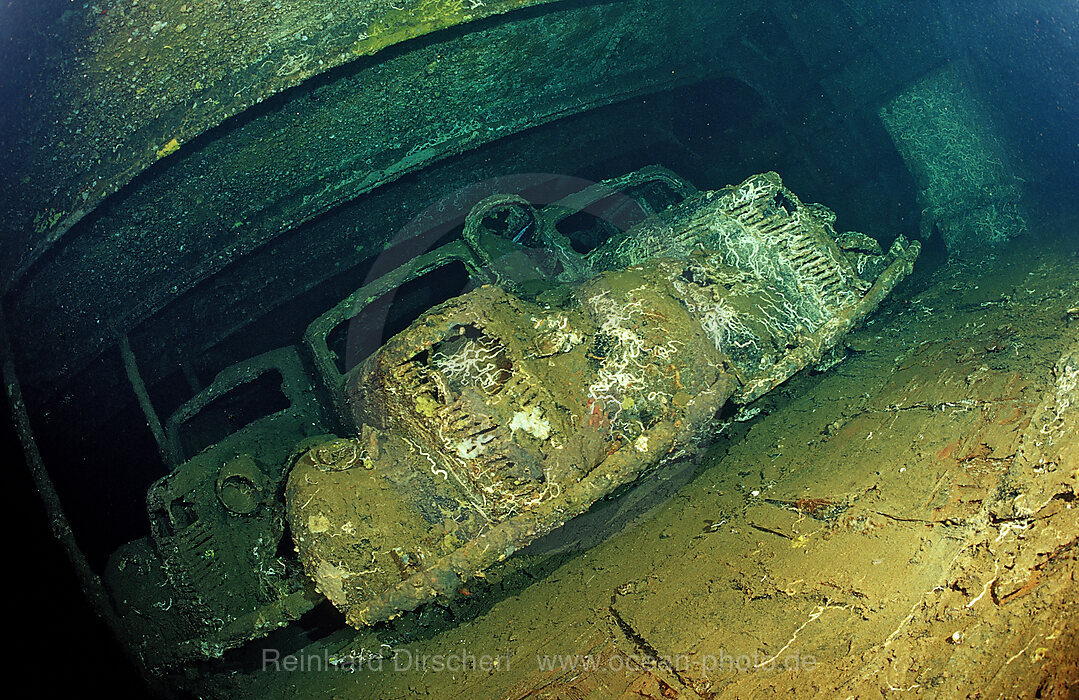 Scuba diver diving in the Umbria shipwreck, Military cars