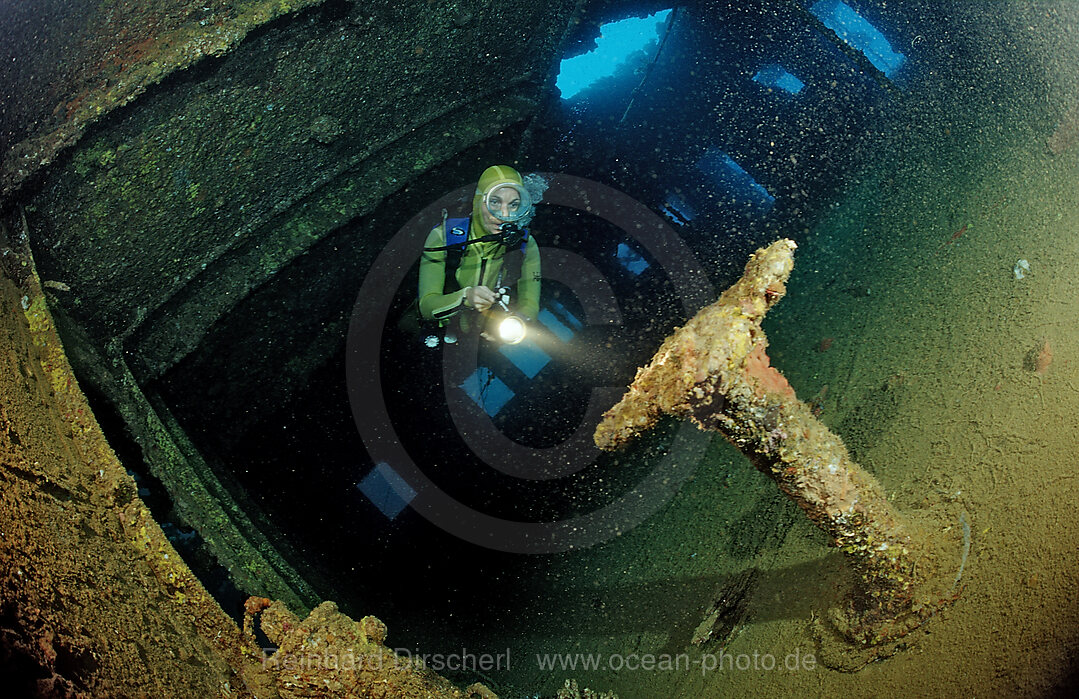 Scuba diver diving in the Umbria shipwreck, Bombs