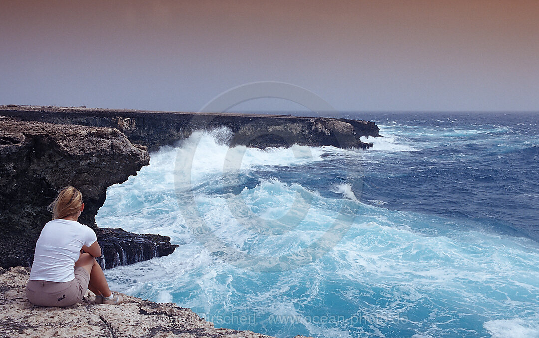 Woman and stormy coast