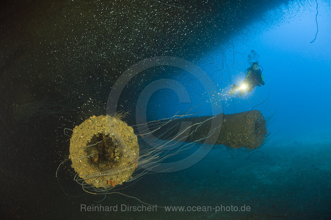 Diver at massive 16-inch 45 Caliber Gun under the HIJMS Nagato Battleship, Bikini Atoll, Micronesia, Pacific Ocean, Marshall Islands