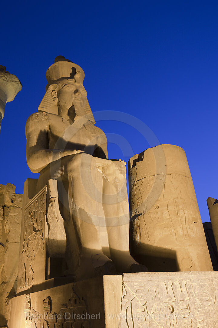 Illuminated Sitting Ramesses II Colossus inside Luxor Temple