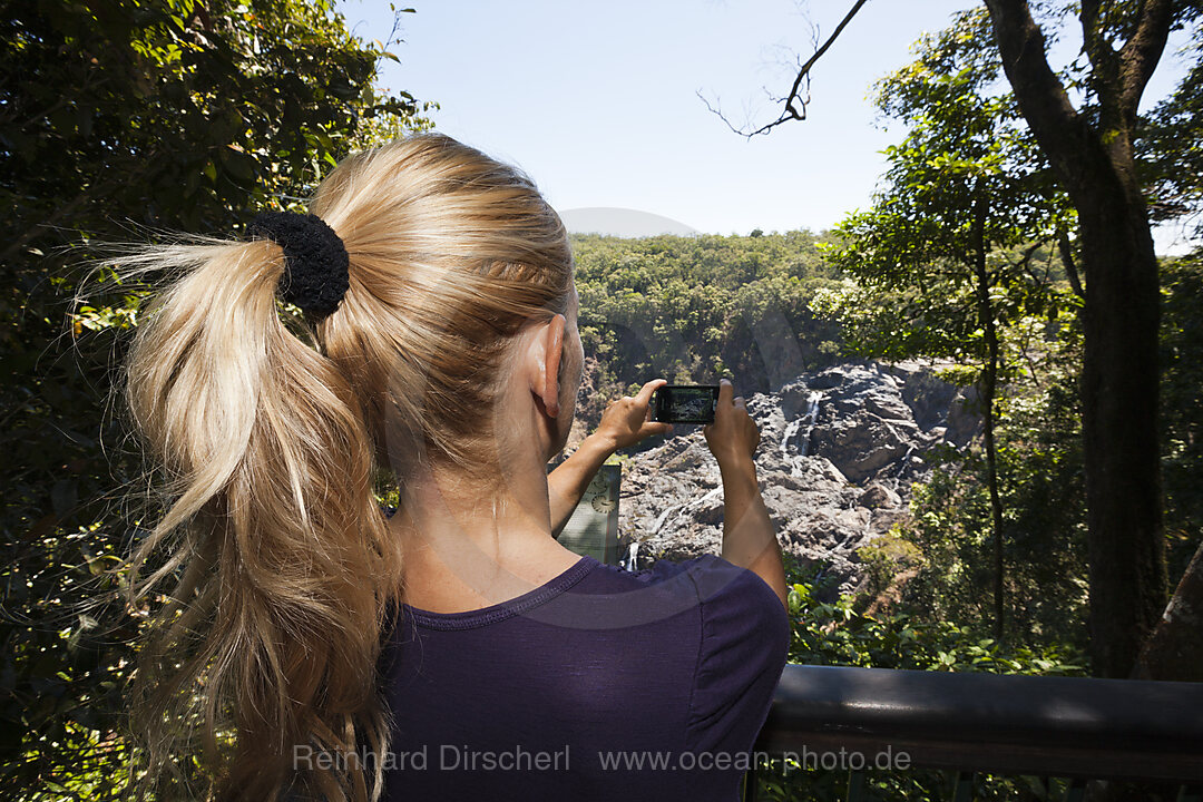Tourist taking images of Barron Falls Waterfall, Kuranda, Cairns, Australia