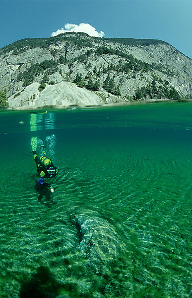 Scuba diver in mountain lake, split image