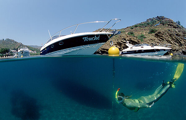 Skin diving in front of a yacht, split image