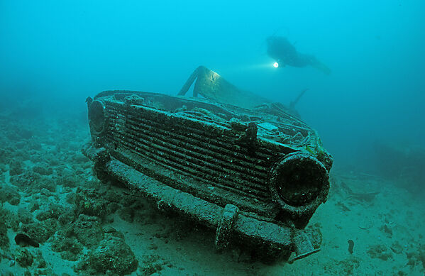 car wreck underwater and scuba diver
