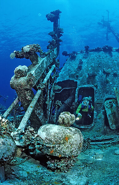 scuba diver explores unknown ship wreck
