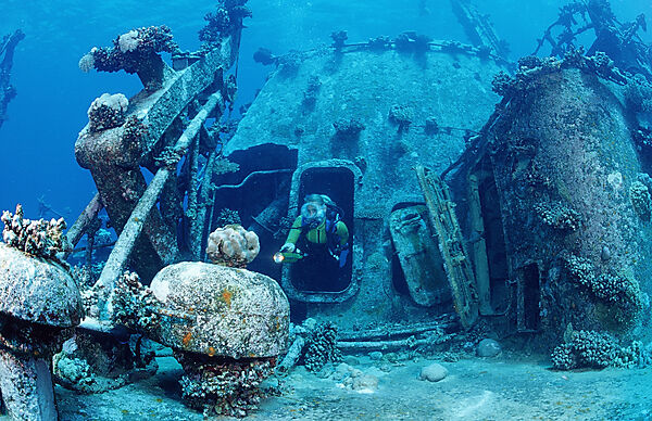 scuba diver explores unknown ship wreck