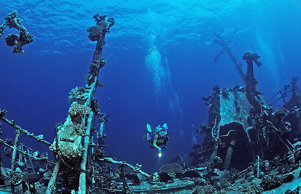 scuba diver explores unknown ship wreck