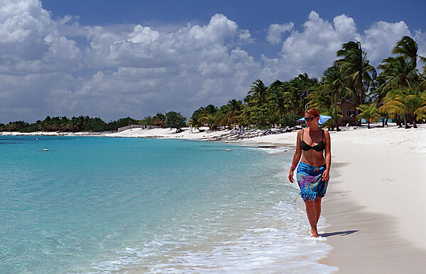 Frau schlendert am Sandstrand