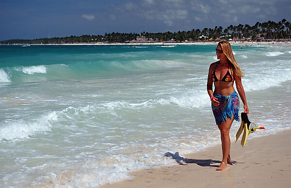 Frau schlendert am Sandstrand