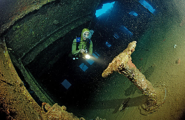Scuba diver diving in the Umbria shipwreck, Bombs
