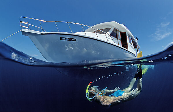 Tauchschiff und Schnorchlerin