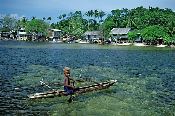 Boy in Outrigger Boat
