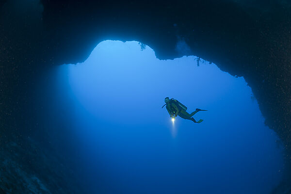 Diver at wide bottom Hole of Blue Hole Cave