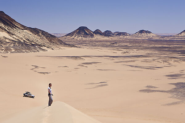 Tourist on 50-Meter Dune in Black Desert